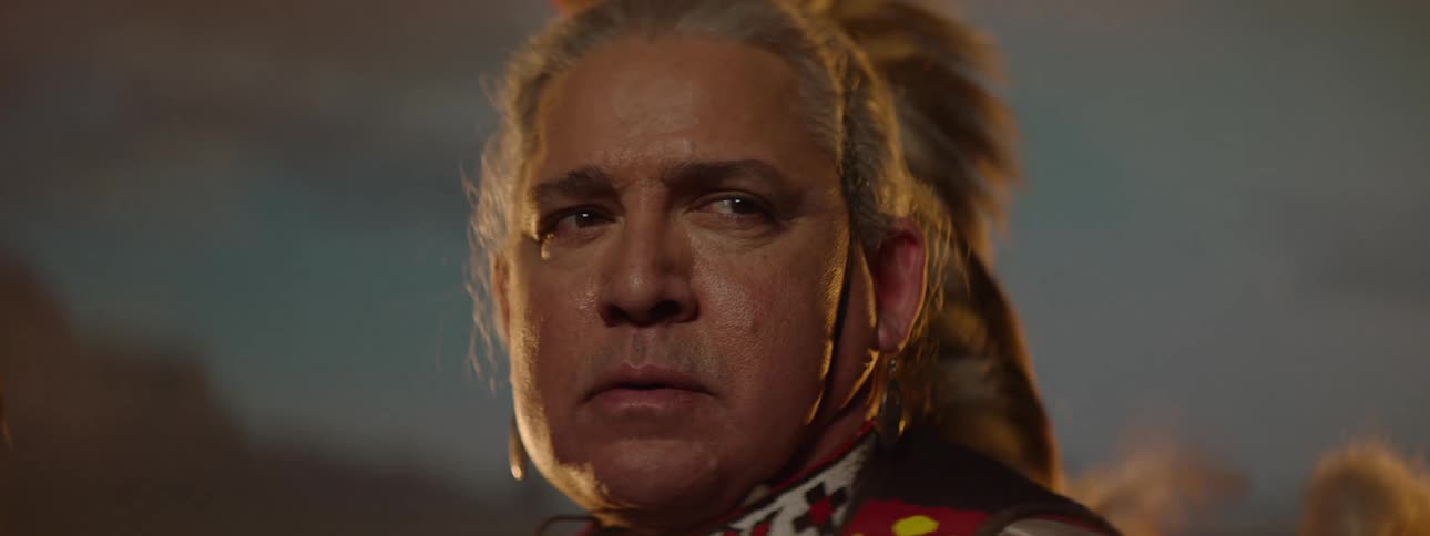 A man wearing a costume looks around