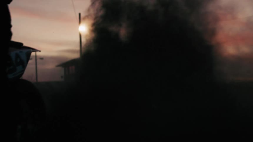 Motorcycle speeding up and releasing dust