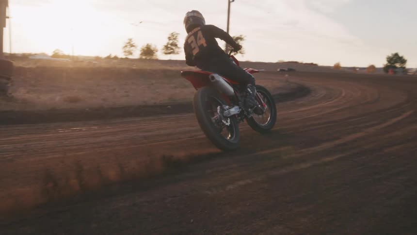 A man makes a steep turn on his dirt bike