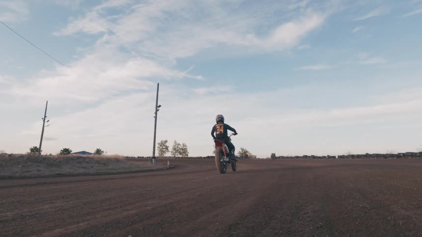 A man in a dirt road race on a racing motorcycle