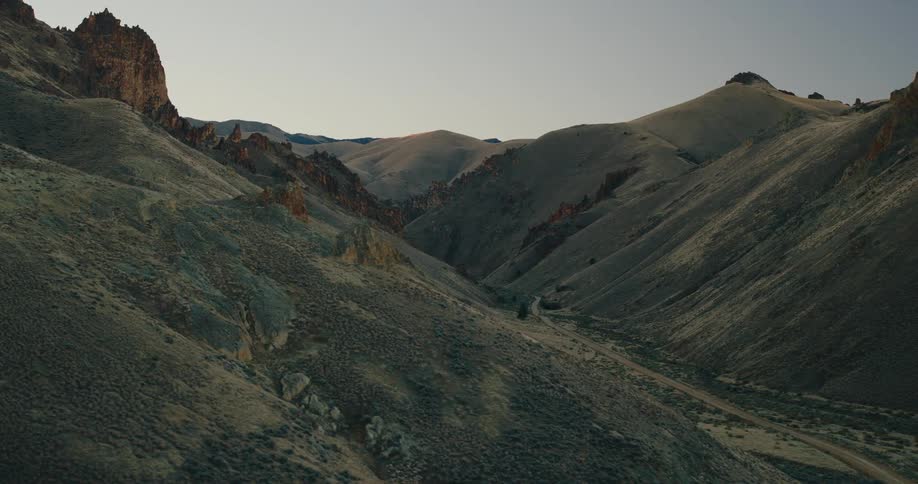 A road winds through the valley of some mountains