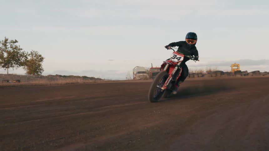 A man races his dirt bike on the trail