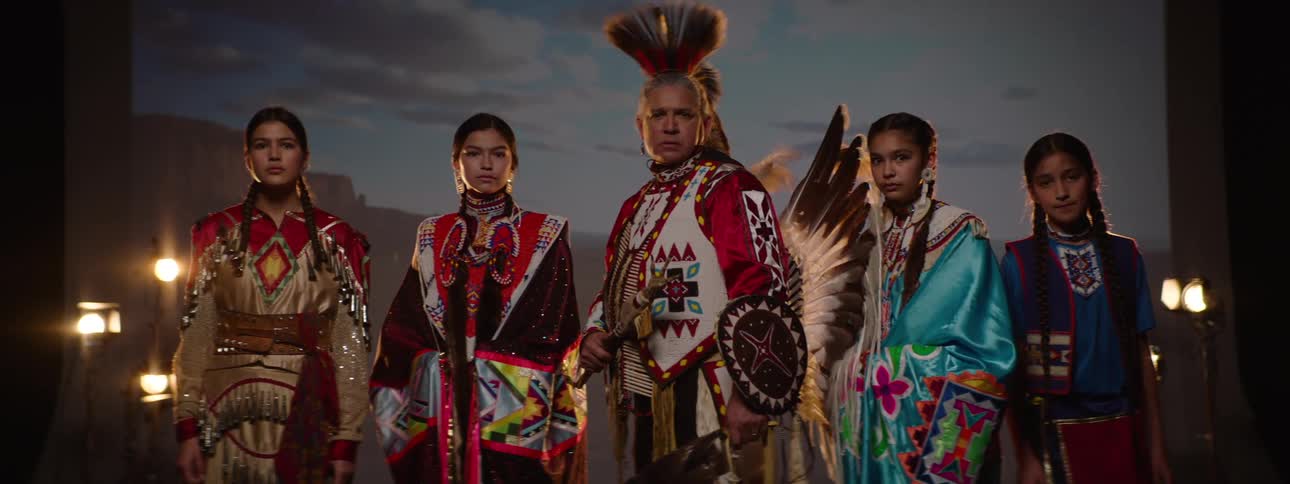 A tribe in costumes turn around
