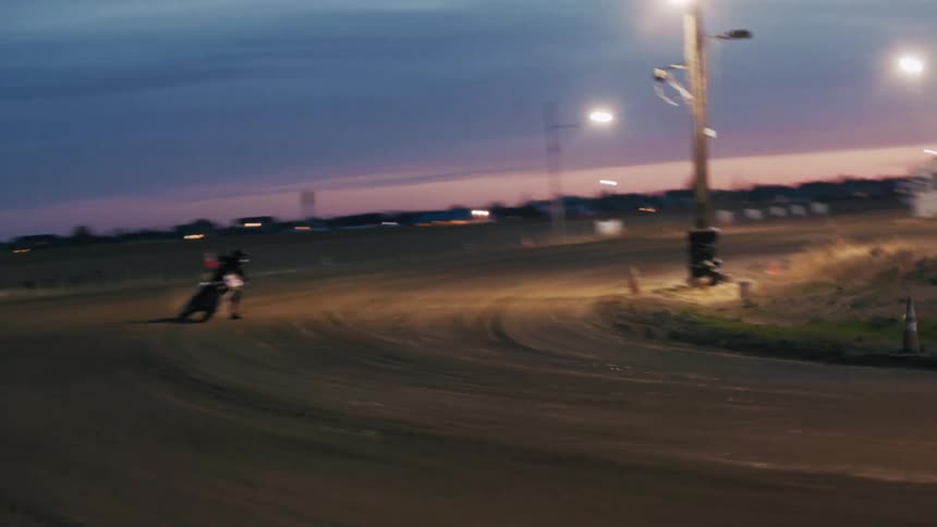 A motorcyclist drives in circles around a dirt path