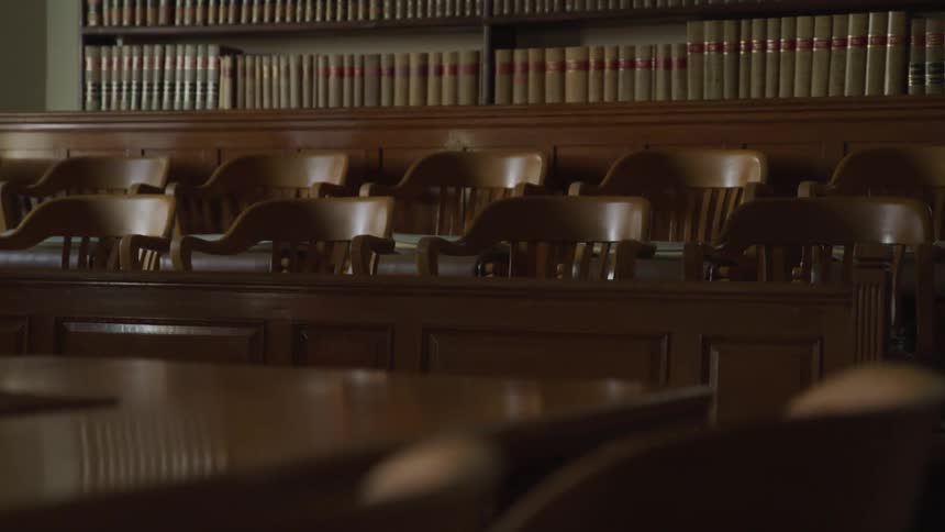 Empty courtroom oak wood chairs in a jury box