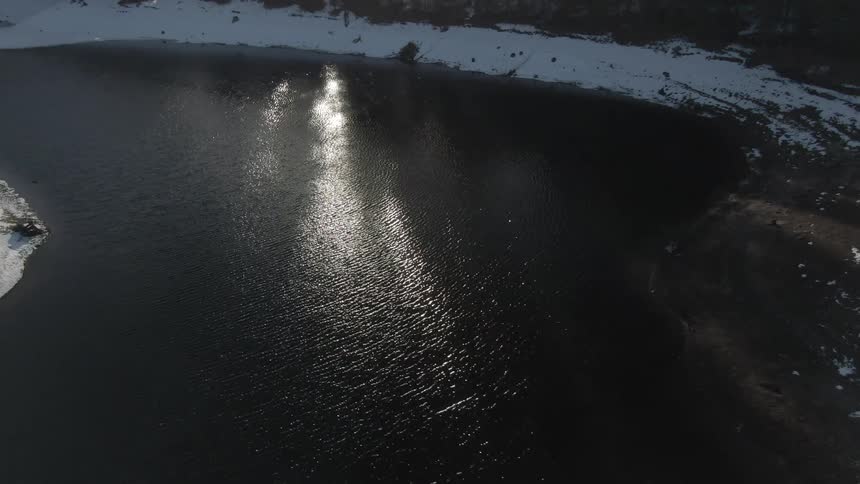 A large lake in winter and lots of snow on the ground