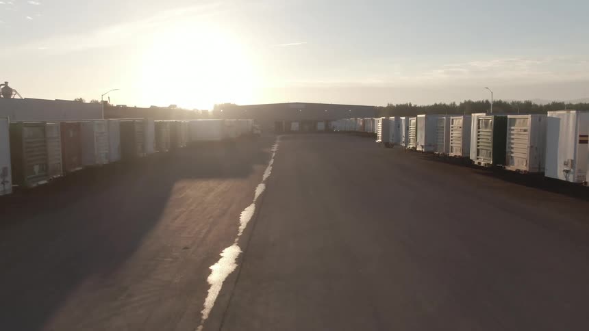Storage containers are lined up along a road