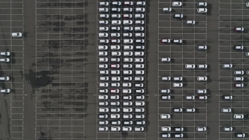 Many cars are parked in the large parking lot