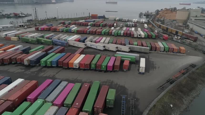 Aerial of multicolored shipping containers in a storage yard