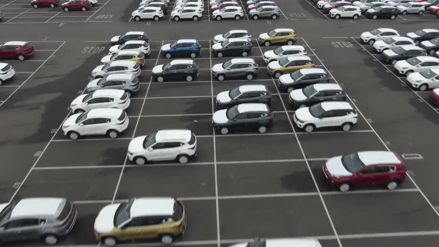 A large parking lot with many parked cars