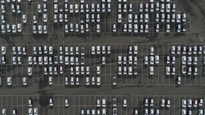Aerial view of a parking lot with several vehicles