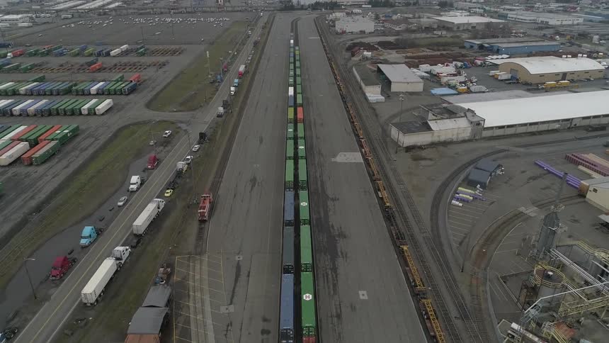The lot is full of warehouses and shipping containers