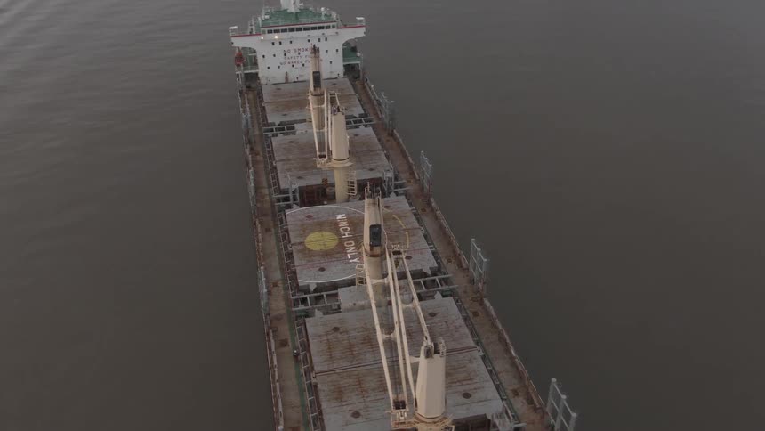Aerial of an empty cargo ship at sea during the day