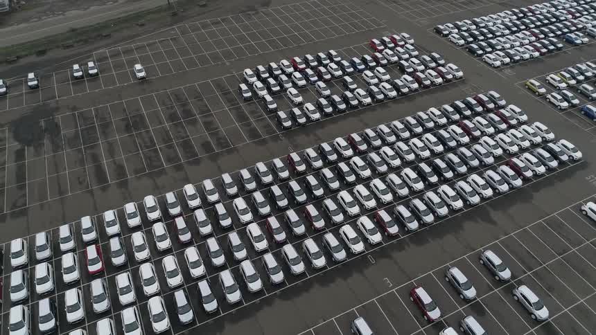 A parking lot with hundreds of parked cars