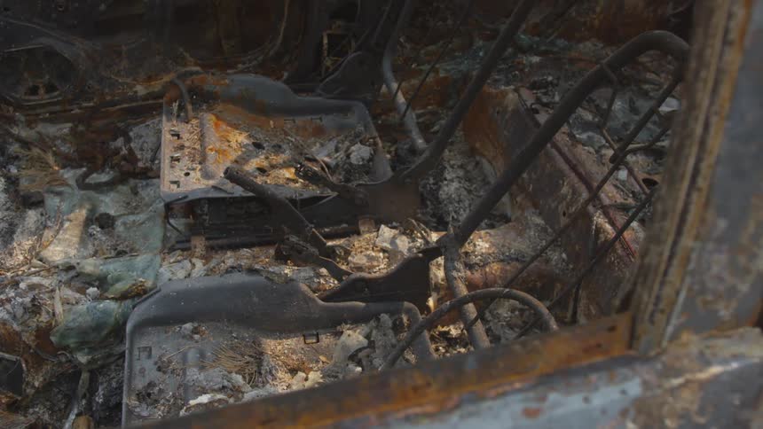The car is rusted and destroyed