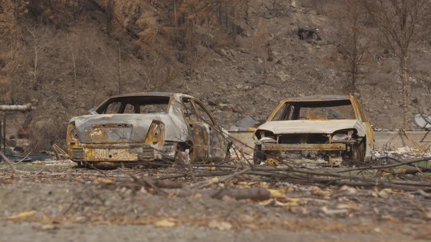 Two cars burned in an area on the edge of a mountain