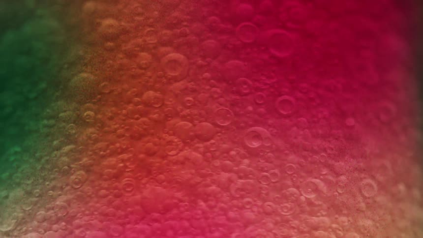 Bubbles move in the colorful drink