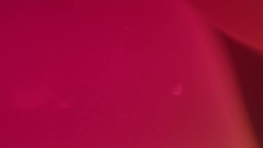 Close up of an abstract liquid in pink color