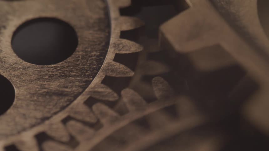 Close up of gears of an analog clock