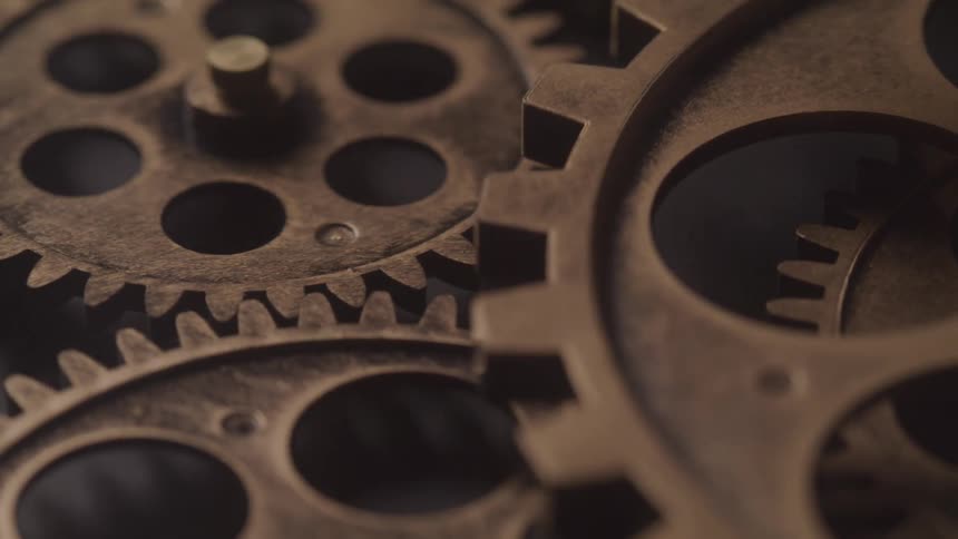 Close up of gears of a moving clock