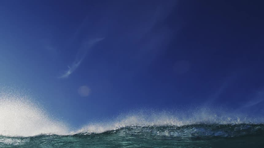 A wave crashes over the camera