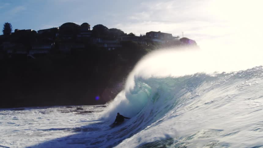 Person surfing a wave in the winter ocean
