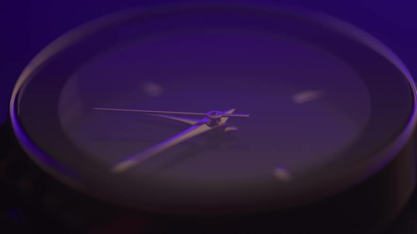 Close up of an analog clock with a metallic hand