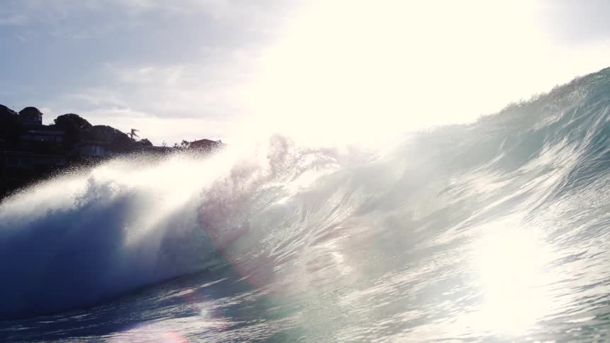 Wave in an ocean breaking with crystal clear water