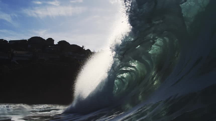 The ocean forming huge waves near the shore on a sunny day