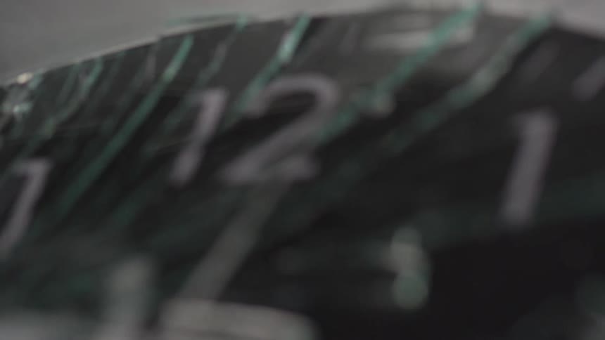 Close up of an analog clock with broken glass