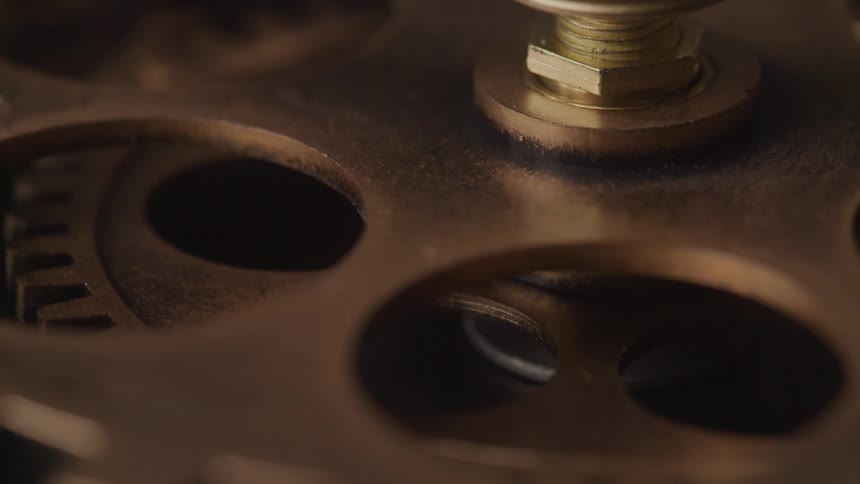 A gear turns slowly