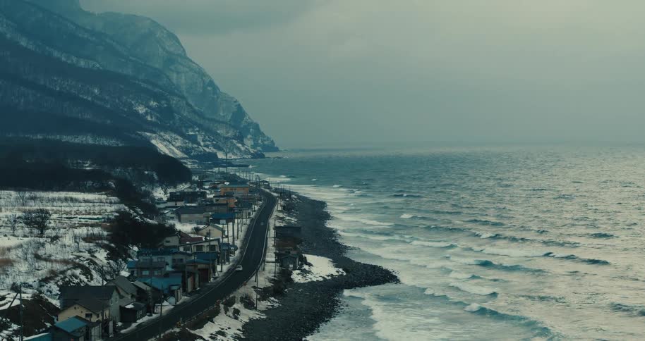 Beach with coast with mountains and houses