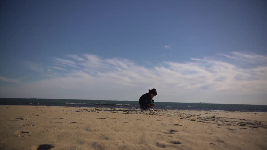 A kid playing in the sand