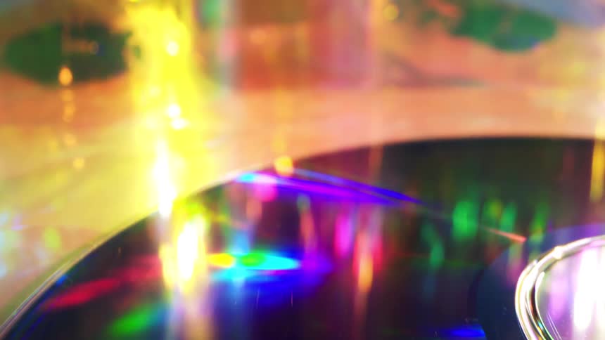 Optical disk reflects the colorful lights shining across a table