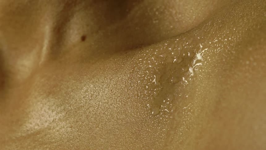 Time lapse of sweat forming and dripping off a persons chest