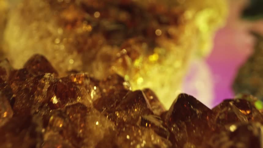 Various golden yellow geode rock crystals glisten and reflect light
