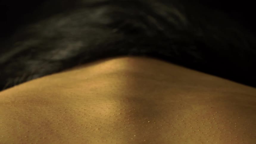 Close up of a womans skin texture on her back and neck