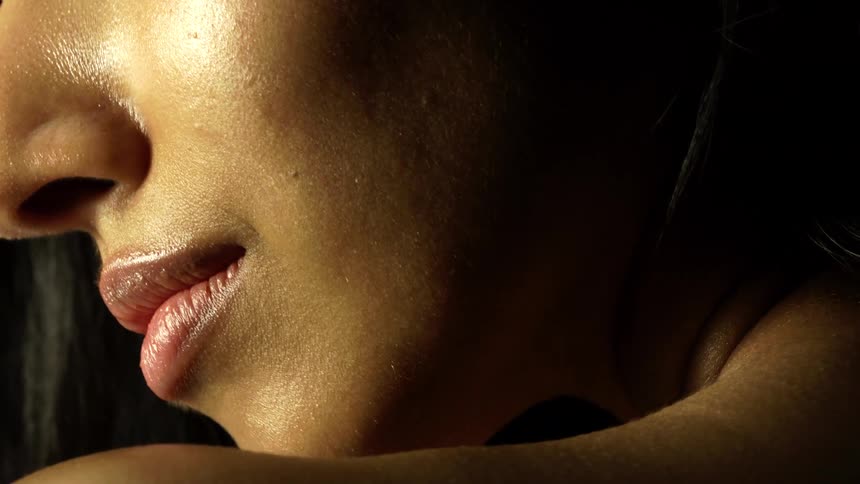 A woman with red lipstick is smiling