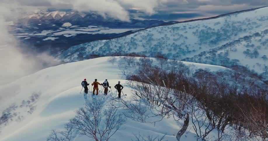 Group of skiers on a snowy mountain peak