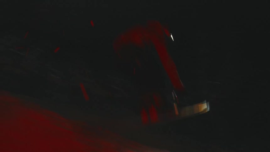 A snowboarder performs a stunt while snowboarding on an snow terrain at night