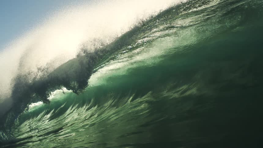 A very large wave rises then crashes