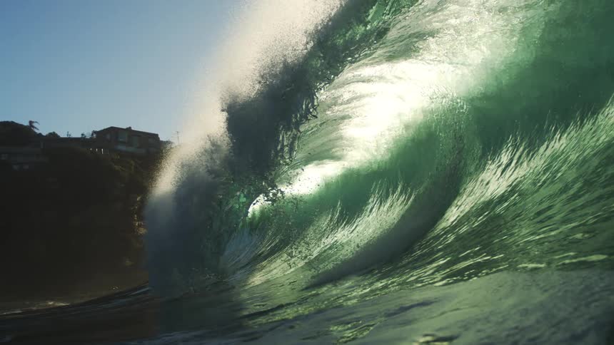 Inside view of a crystal clear tubular wave breaking in the ocean
