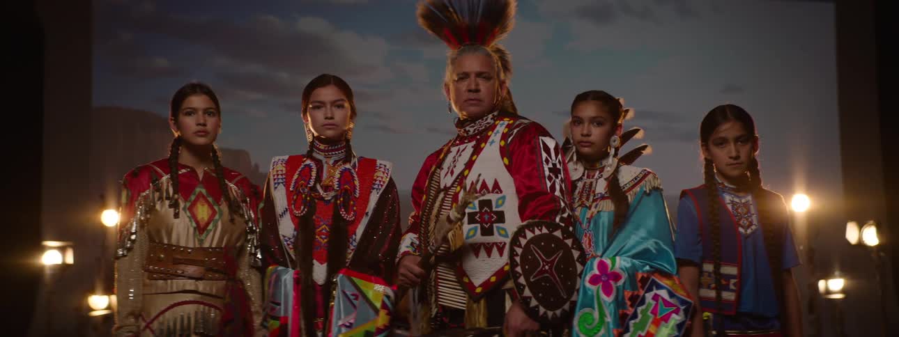 A group of people are modeling tribal costumes