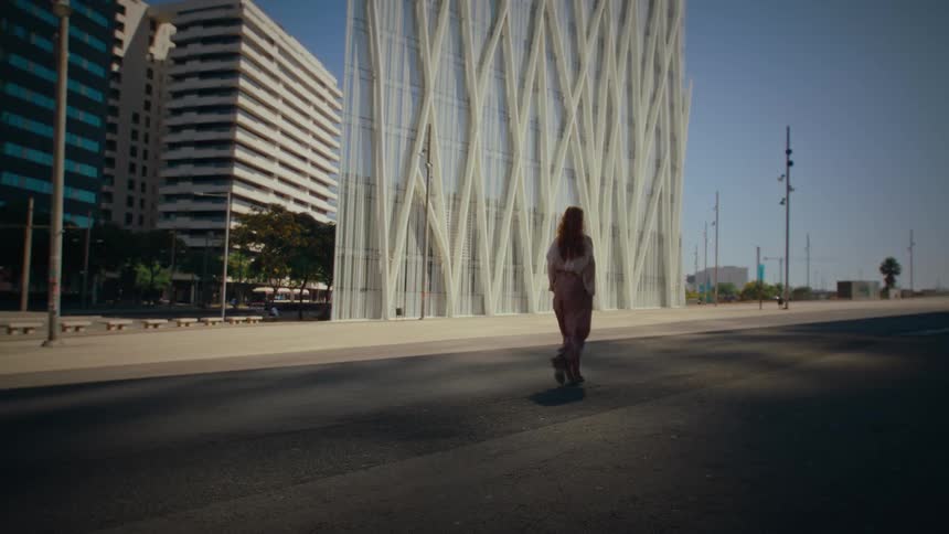 Woman walking on the street of an urban city during the day