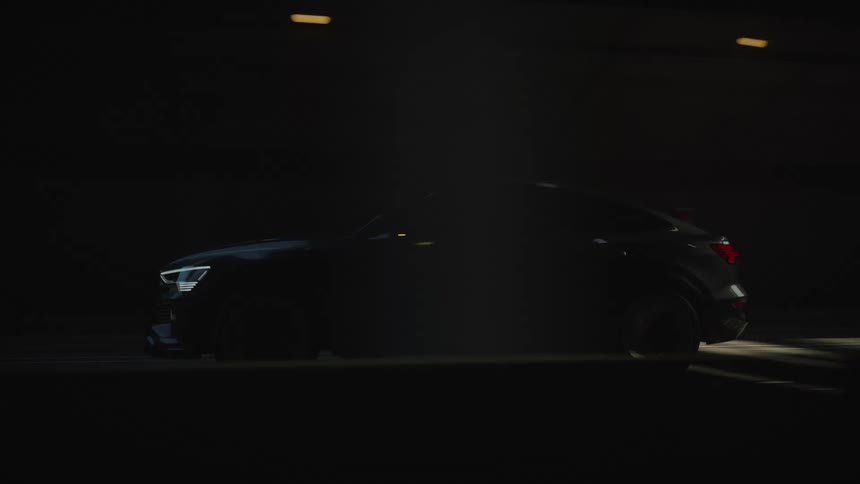 The car is driving through the tunnel fast