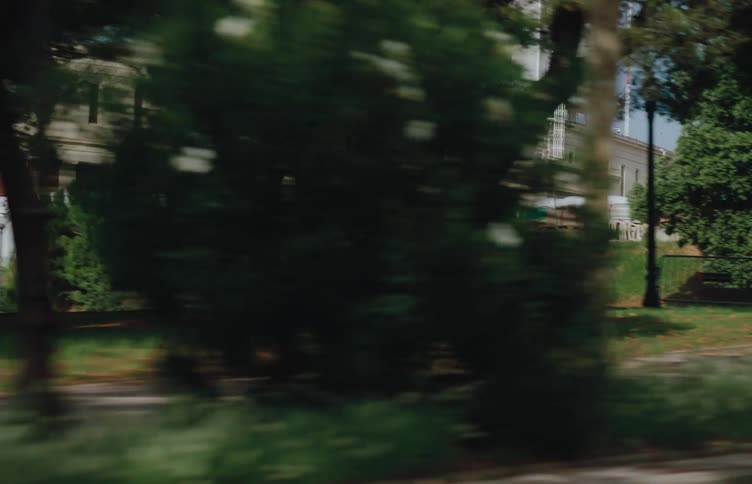 An audi etron sportback driving on a road surrounded by trees at midday