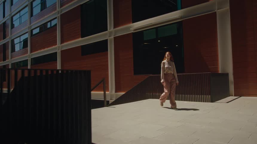 A woman turns and looks at the buildings