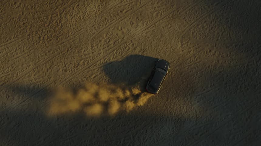 Aerial of a car drifting in the desert during daytime