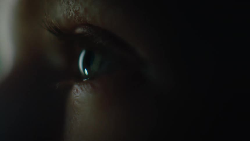 Extreme closeup of a human eye in warm lighting