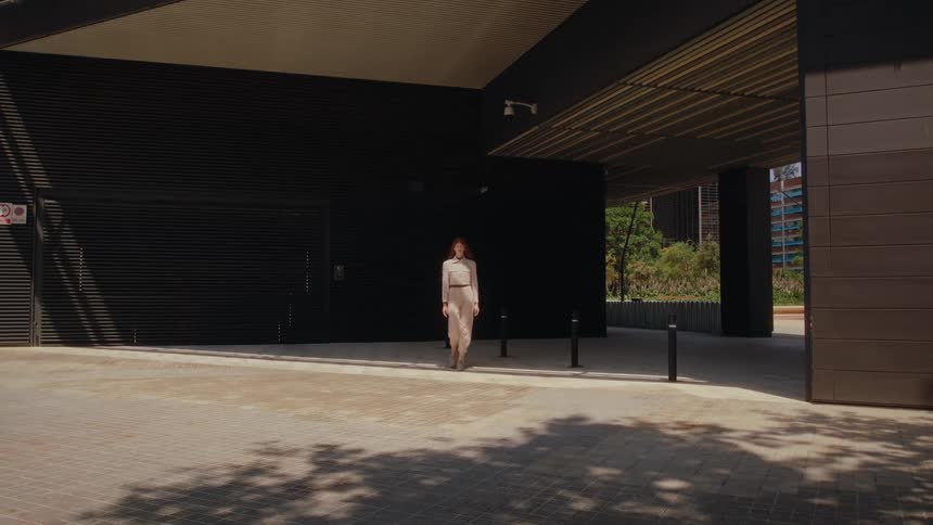 Redheaded woman parading outdoors through the city